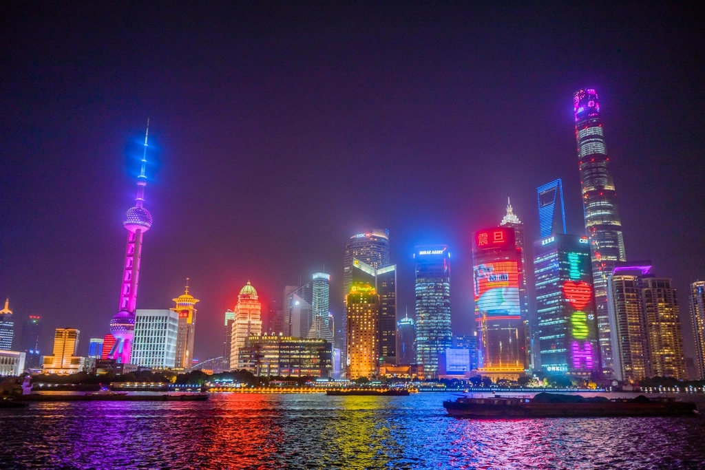 Neon-lit night skyline of a coastal metropolis, the real-world look ANANTA's Nova City is built on